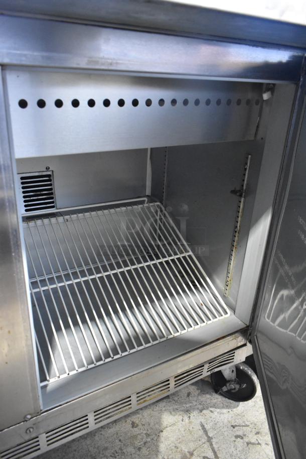 Beverage Air SPE48-18M stainless steel prep table with interior shelving, open door view, commercial casters, 115V, 1 phase.