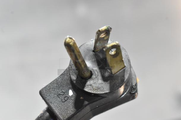The image features a close-up of a three-prong electrical plug, typically used for appliances.