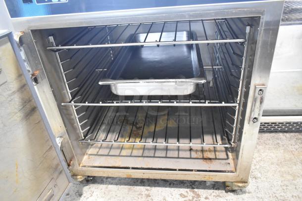 2019 Alto Shaam 750-S stainless steel heated holding cabinet, on casters, 120V, 1 phase, with interior racks. Some rust visible.