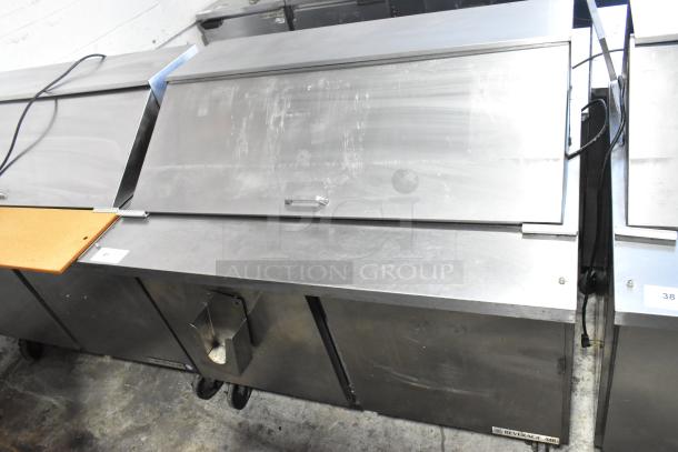 Beverage Air SPE48-18M stainless steel sandwich prep table with cover, commercial casters, scratches visible, 48-inch.
