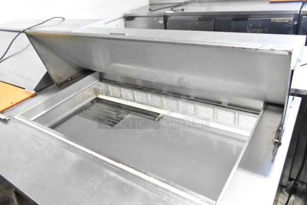 Beverage Air SPE48-18M stainless steel sandwich prep table, bain marie lid open, on casters, used condition.