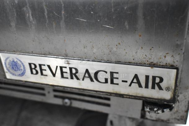 Beverage Air SPE48-18M prep table, stainless steel, visible logo plate, on casters, showing signs of wear.