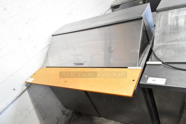 Beverage Air SPE48-18M stainless steel prep table, 115V, on casters. Features a hinged lid and wooden cutting board.