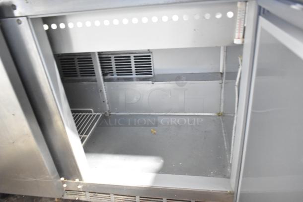 Beverage Air SPE48-18M stainless steel sandwich salad prep table, open view, stainless interior, on casters, 115 volts.