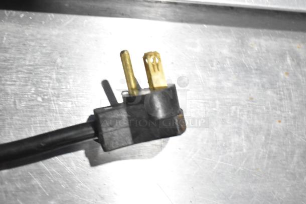 Stainless steel finish with visible scratches, shows a close-up of electrical plug for Beverage Air SPE48-18M prep table.
