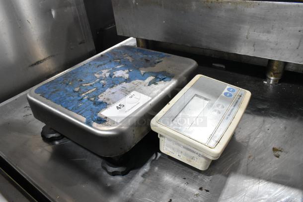 AND FG-30KBM countertop food scale, 60-pound capacity, worn platform surface, includes label with lot information.