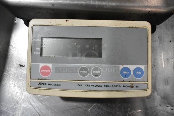 AND FG-30KBM countertop food scale, 60 lb capacity, visible wear and markings, includes ON/OFF and tare buttons.