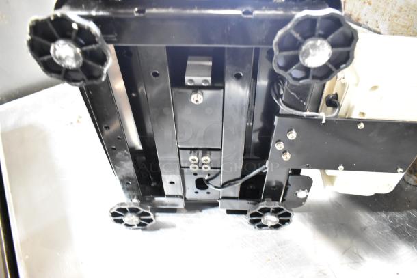 AND FG-30KBM countertop food scale base, showing four black adjustment knobs and visible wiring, 60 lb capacity.
