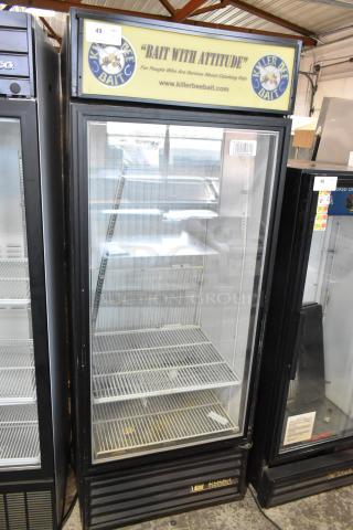 True GDM-26F-LD commercial freezer with a single glass door and poly-coated racks. 115 volts, 1 phase. "Bait with Attitude" sign.