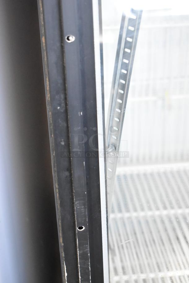 True GDM-26F-LD reach-in freezer, metal frame, single door, poly-coated racks, 115V, 1 Phase, visible shelving details.