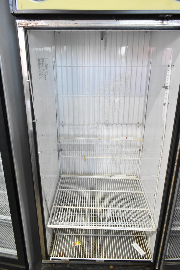 True GDM-26F-LD single door freezer merchandiser with poly-coated racks, metal frame, some wear visible, 115 volts, 1 phase.