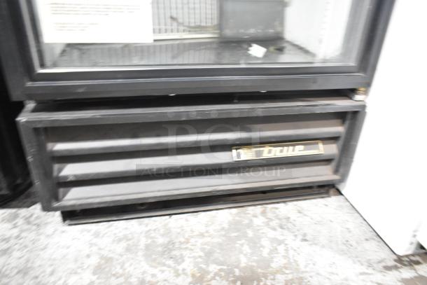 True GDM-12 commercial cooler with single glass door, metal body, and poly coated racks. Features 115V, 1 Phase. Brand label visible.