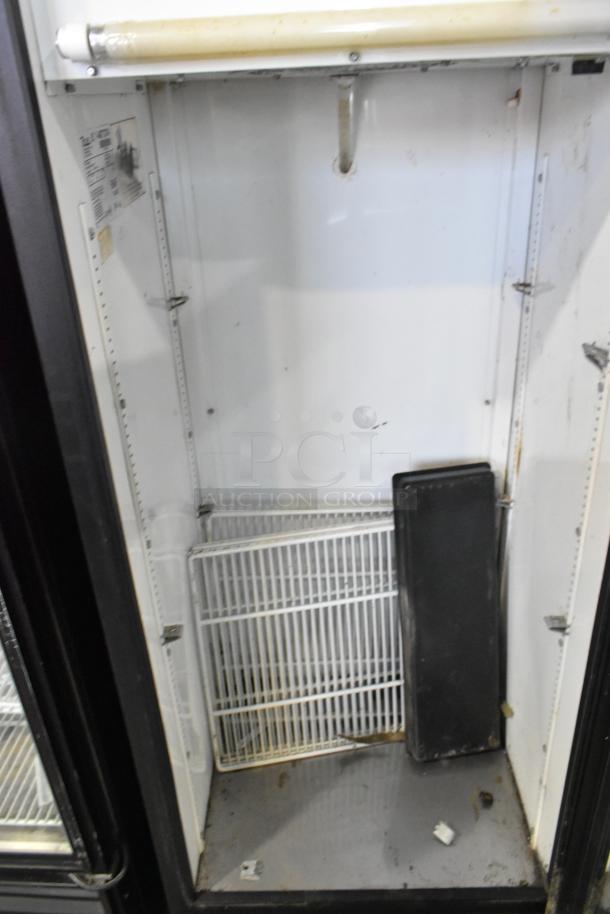 True GDM-12 metal commercial cooler, single door, with poly coated racks, 115V, 1 phase, visible internal wear.