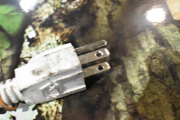 Close-up of a power plug, part of a Mossy Oak BD-180U-MSOK Single Door Reach In Freezer, 115 Volts, 1 Phase.