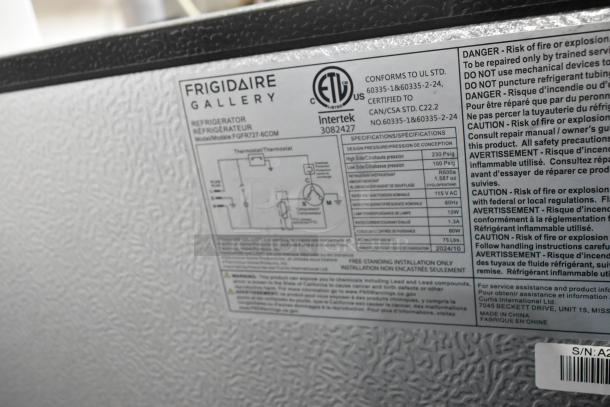 Frigidaire Gallery FGFR727-6COM stainless steel cooler with freezer. 115V, 1 phase. Model and specifications label visible.