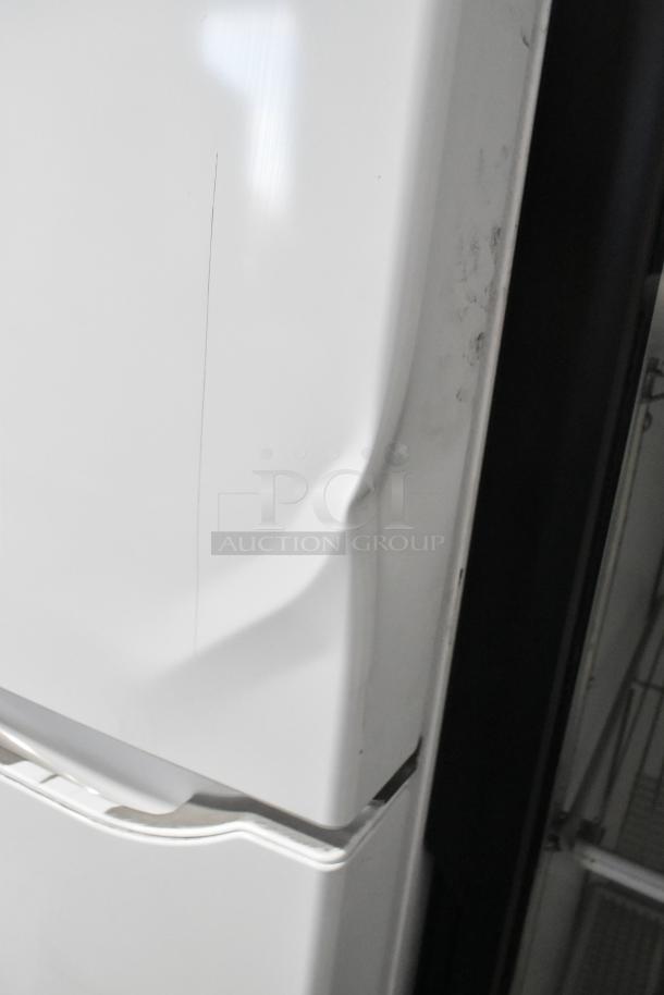 LG LTCS20020W/05 reach-in cooler with freezer, showing minor dents and scratches. 115 volts, 1 phase.