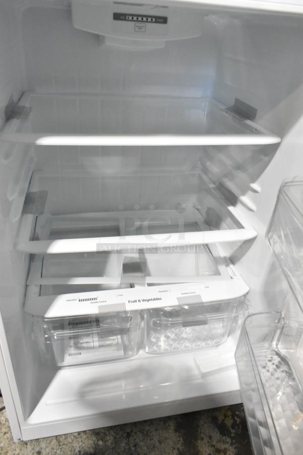 LG LTCS20020W/05 reach-in cooler with freezer shown open. Features multiple shelves and crispers labeled for fruits and vegetables.