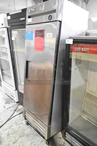 2017 True T-19F stainless steel commercial freezer on casters, two needing attachment. Features poly-coated racks. Model T-19F.