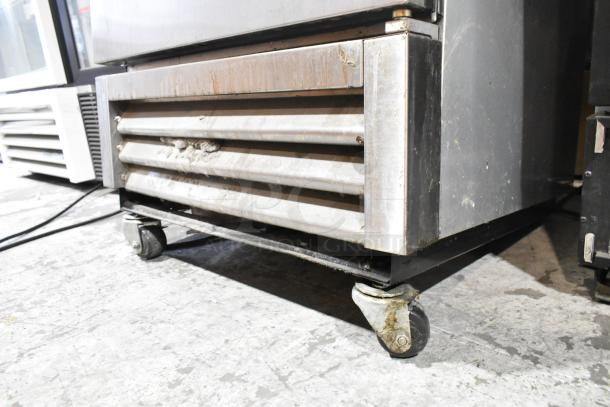 2017 True T-19F stainless steel commercial freezer on casters, worn condition, 115V, 1 phase, needs 2 casters reattached.
