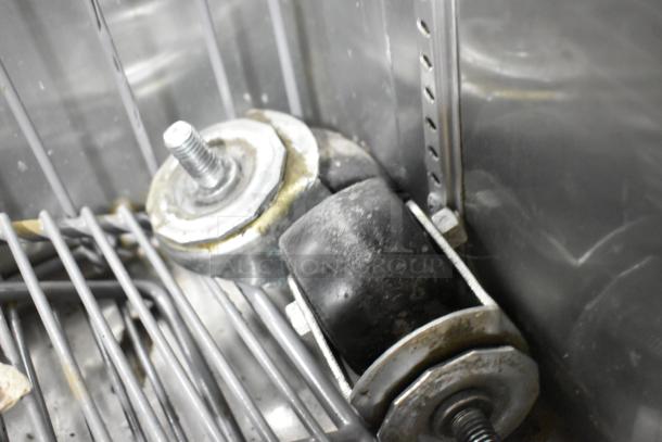 2017 True T-19F stainless steel freezer with poly-coated racks and commercial casters; two casters need attachment.
