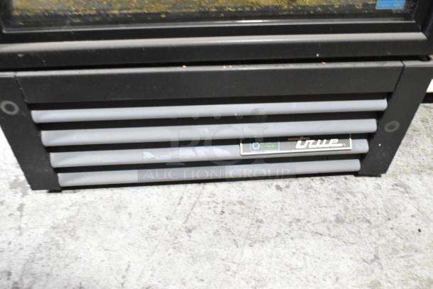 2018 True GDM-12-HC single door cooler, black, poly-coated racks, 115V, 1 phase, True logo on vent panel.