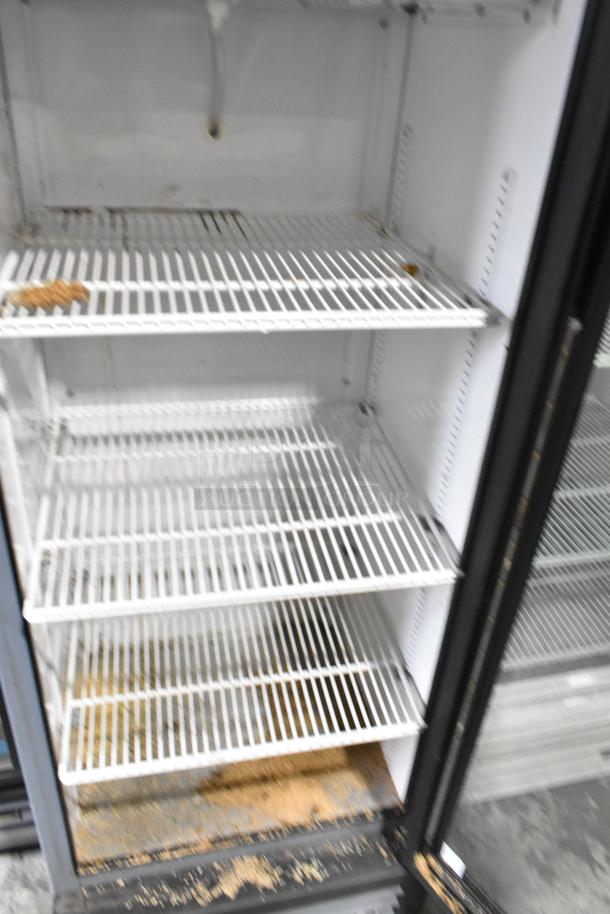 2018 True GDM-12-HC single door cooler with poly-coated racks, displays interior condition with visible wear. 115 Volts, 1 Phase.