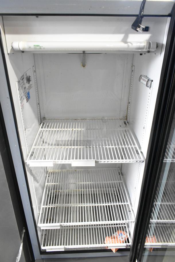 True GDM-12 single door reach-in cooler merchandiser with poly-coated racks, showing interior shelving. 115 volts, 1 phase.