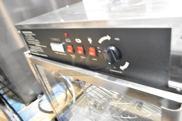 Brand new Benchmark USA 51018 humidified rotating pizza/pretzel warmer. Features pretzel rack and 18" pizza rack, 120V, 1 phase.