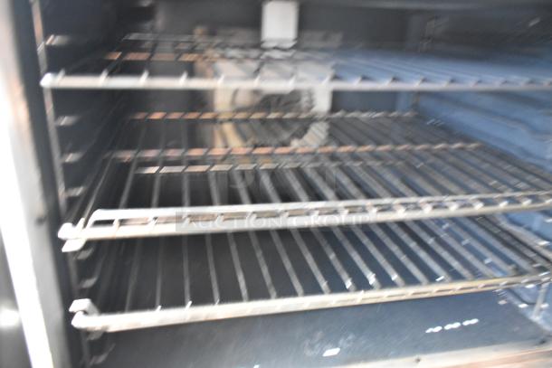 2 Vulcan VC4GD stainless steel convection ovens with view-through doors and metal racks. Commercial use, natural gas.