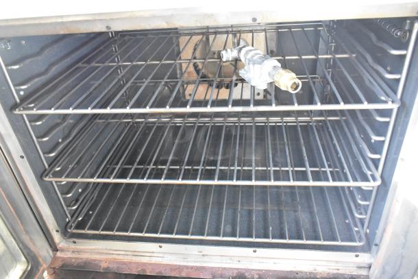 Vulcan VC4GD stainless steel full-size convection oven with view doors, metal racks, thermostatic controls, natural gas powered.