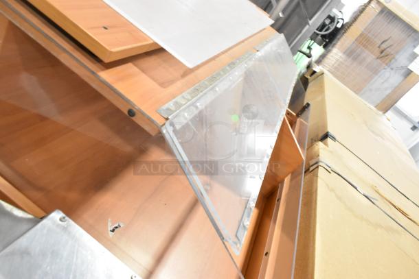 Wood pattern dry merchandiser with transparent panels, angled display, and metal hinges. Good condition with minor scratches.