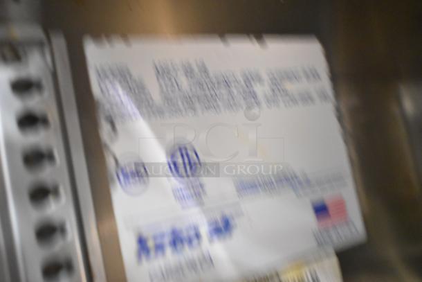 Turbo Air MST-48-18 label, indicating model and certifications; blurred, showing partial specifications and USA flag.