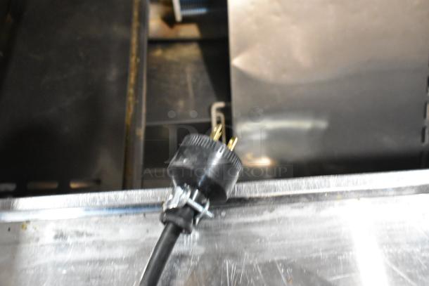 Turbo Air MST-48-18 stainless prep table with visible power cord plug, condition suggests commercial use.