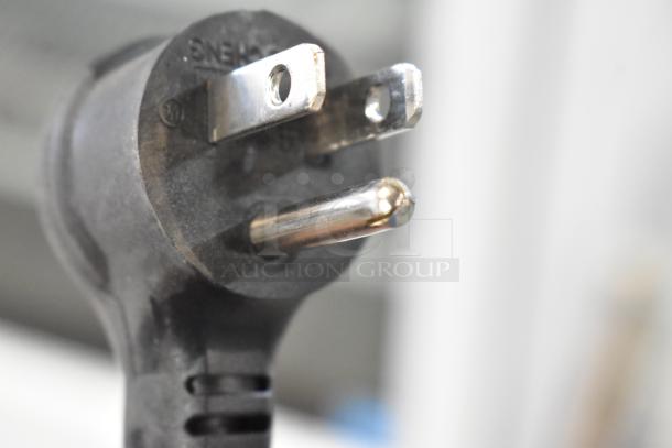 Close-up of a power plug for a 2021 True TSCI-600R-G-PH commercial cooler, 115 volts, 1 phase.