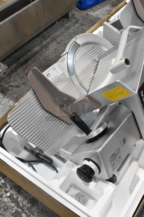 Bizerba SE 12 US metal commercial meat slicer, 120V, 1 phase, shown in packaging; includes adjustment dial and safety labels.
