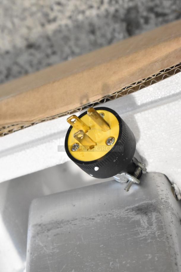 Bizerba SE 12 US meat slicer plug. Yellow 120V, 1 phase connector, attached to metal base. Suitable for commercial use.