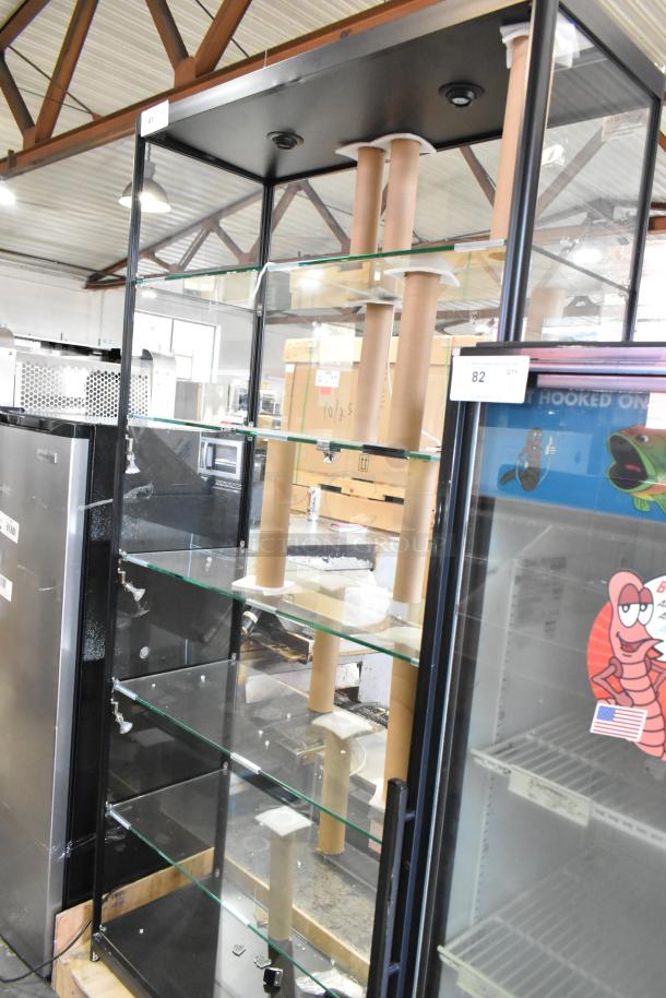 Metal and glass dry display case with several glass shelves. Note visible broken glass on multiple shelves.