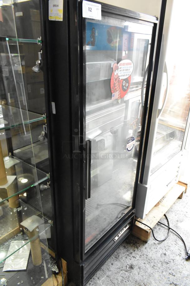 True GDM-12 commercial single door cooler, used, with poly coated racks, 115V, visible brand logo and auction tag.