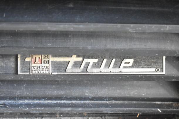 True GDM-12 metal cooler logo detail, showcasing the brand's signature emblem.