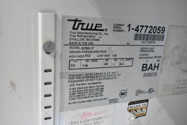 True GDM-12 commercial cooler tag showing model, voltage, specs, and NSF certifications. Made in USA. Serial 1-4772059.