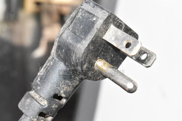A close-up of a power plug with visible wear, suitable for the Premium PRF90DX Cooler, 115 Volts, 1 Phase.