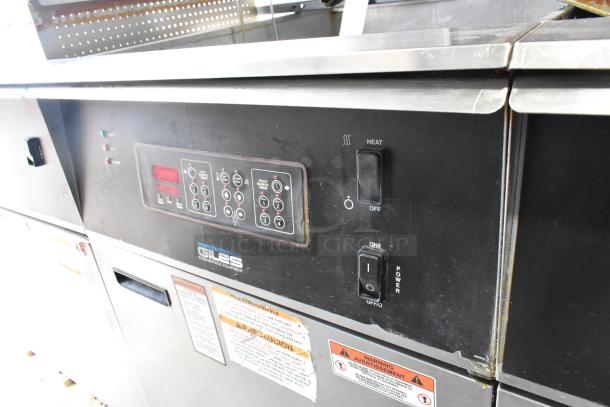 Giles EOF-24 stainless steel 3-bay electric fryer with center dumping station, control panel, and safety labels.