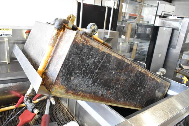 Giles EOF-24 commercial electric 3-bay fryer, stainless steel, center dumping station, on casters, visible wear.