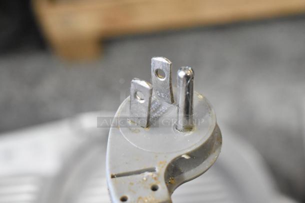 Three-prong plug of Hobart 2912 Commercial Meat Slicer. Stainless steel, 115 volts, 1 phase. Close-up view.