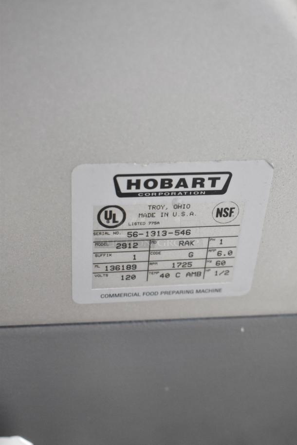 Hobart 2912 commercial countertop meat slicer label, showing model, serial number, 115 volts, 1 phase, made in USA.