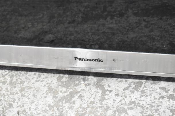 Panasonic NN-SN975S metal countertop microwave oven, partially visible with logo. Model NN-SN975S, 120V, 1-phase.