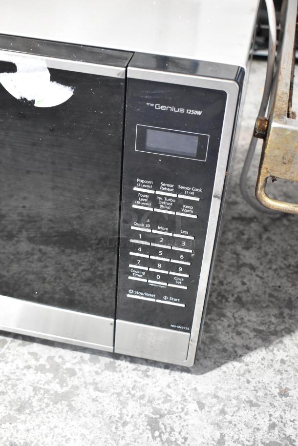 Panasonic NN-SN975S metal countertop microwave oven with keypad, 1250W, and digital display. Condition: used. Model number visible.