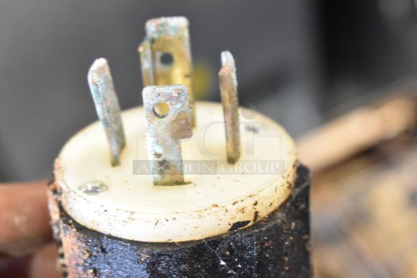 Close-up of a worn electrical plug connected to a Middleby Marshall DZ33T CTX commercial pizza oven.