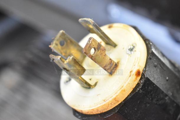 Close-up of a rusted electrical plug with visible metal prongs on a Middleby Marshall DZ33T CTX pizza oven, 208/240 Volts.