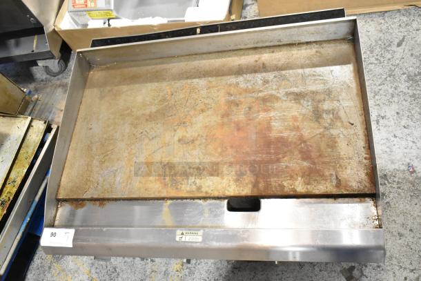 Cooking Performance Group CPG 351GMCPG36 stainless steel gas griddle, 90,000 BTU, shows signs of use, with visible surface wear.